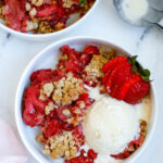 Strawberry Crisp served in a bowl with a scoop of ice cream