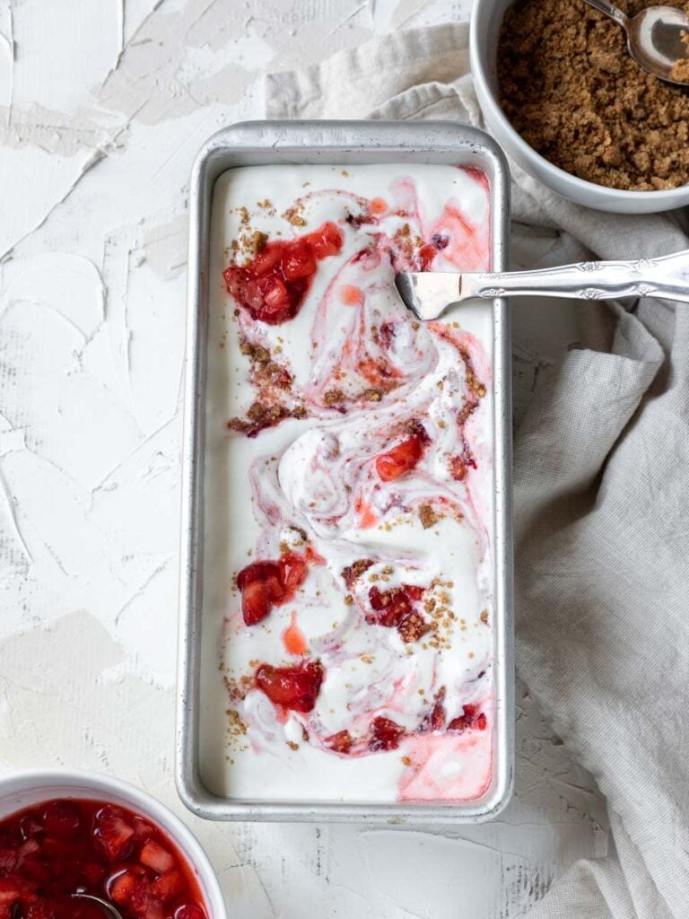 mixing strawberries and ice cream in a pan