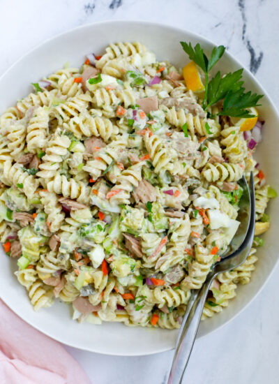 tuna pasta salad top down view with spoons inserted in the salad