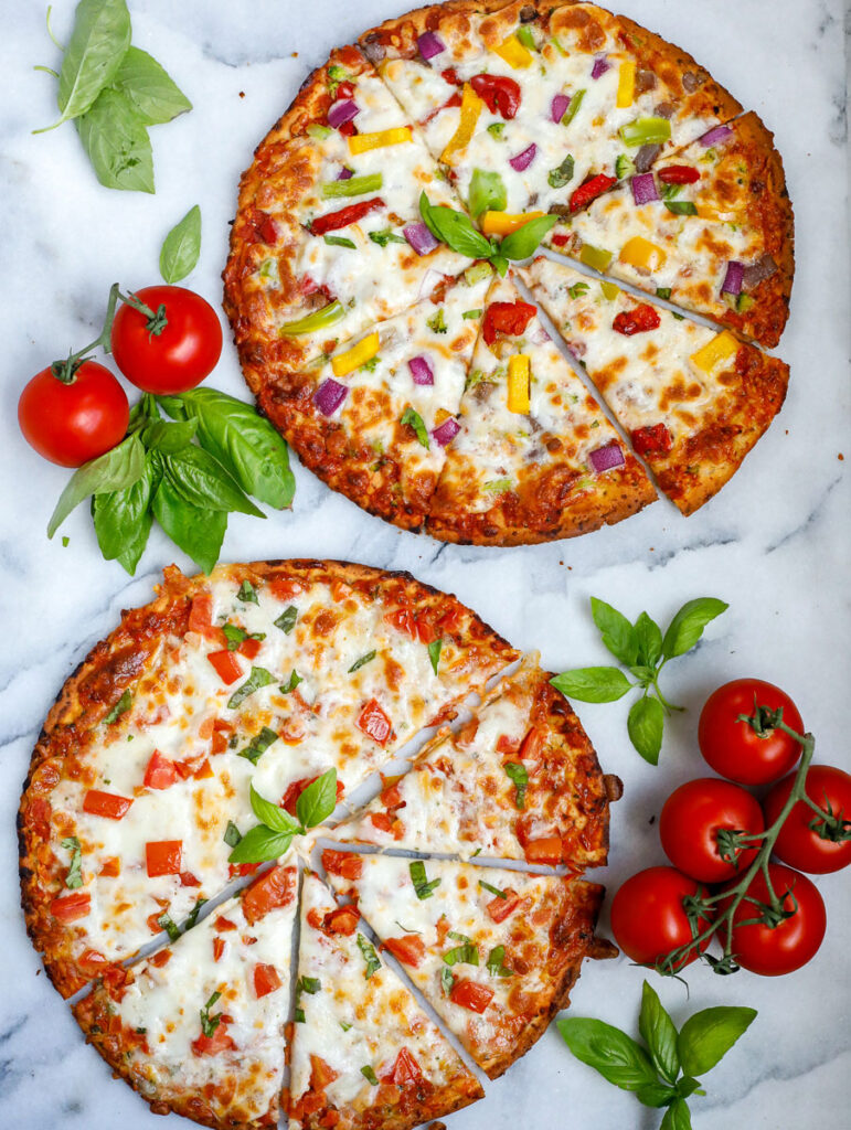 top down shot showing both cauliflower pizzas after baking