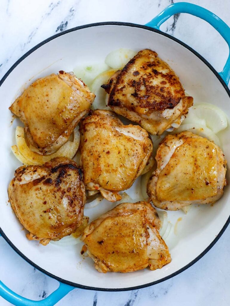 overhead shot of chicken thighs in pot