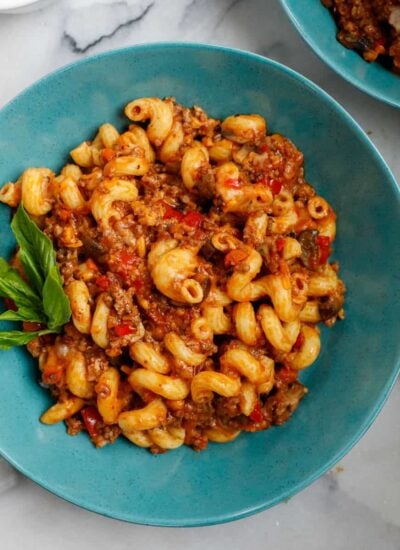 ground beef pasta cooked and served on a blue plate