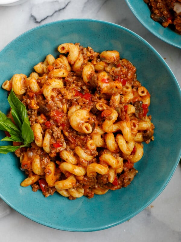 ground beef pasta cooked and served on a blue plate