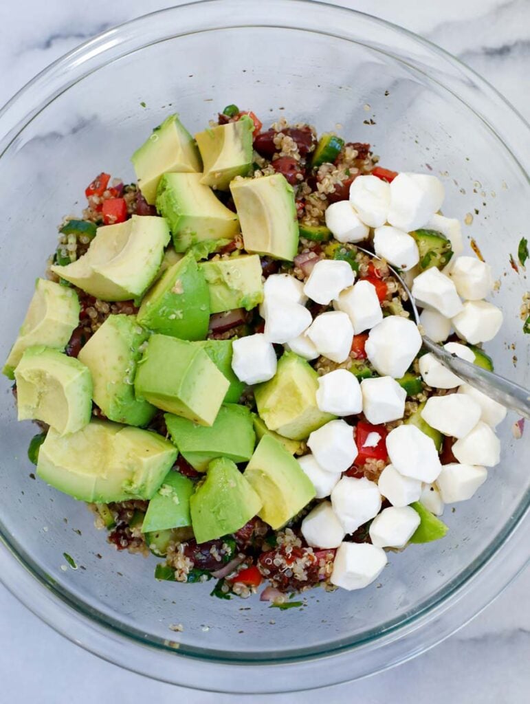 diced avocado and mozzarella balls in a bowl