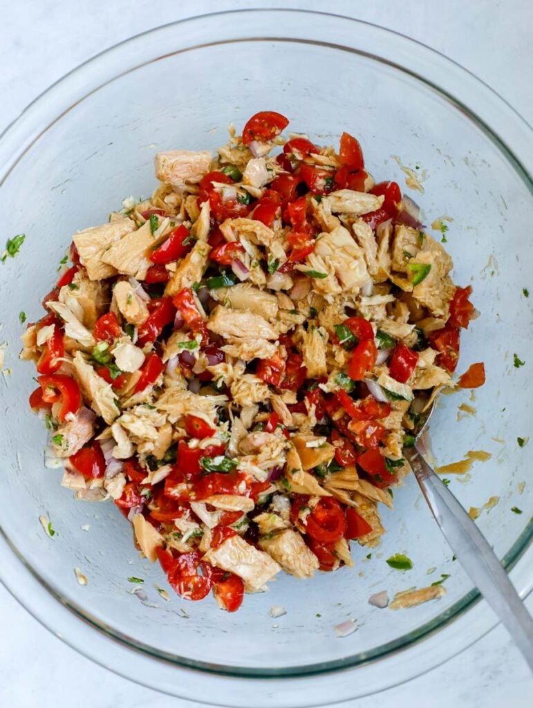 mixing tuna and tomatoes 