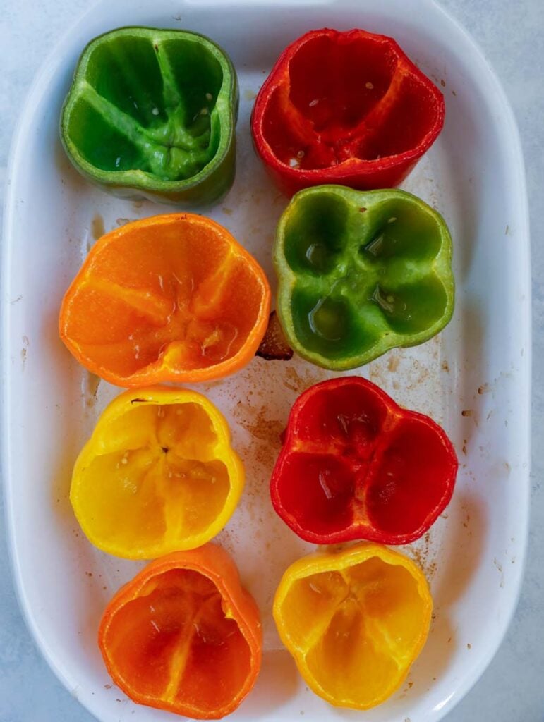 hollowed peppers in a baking dish.