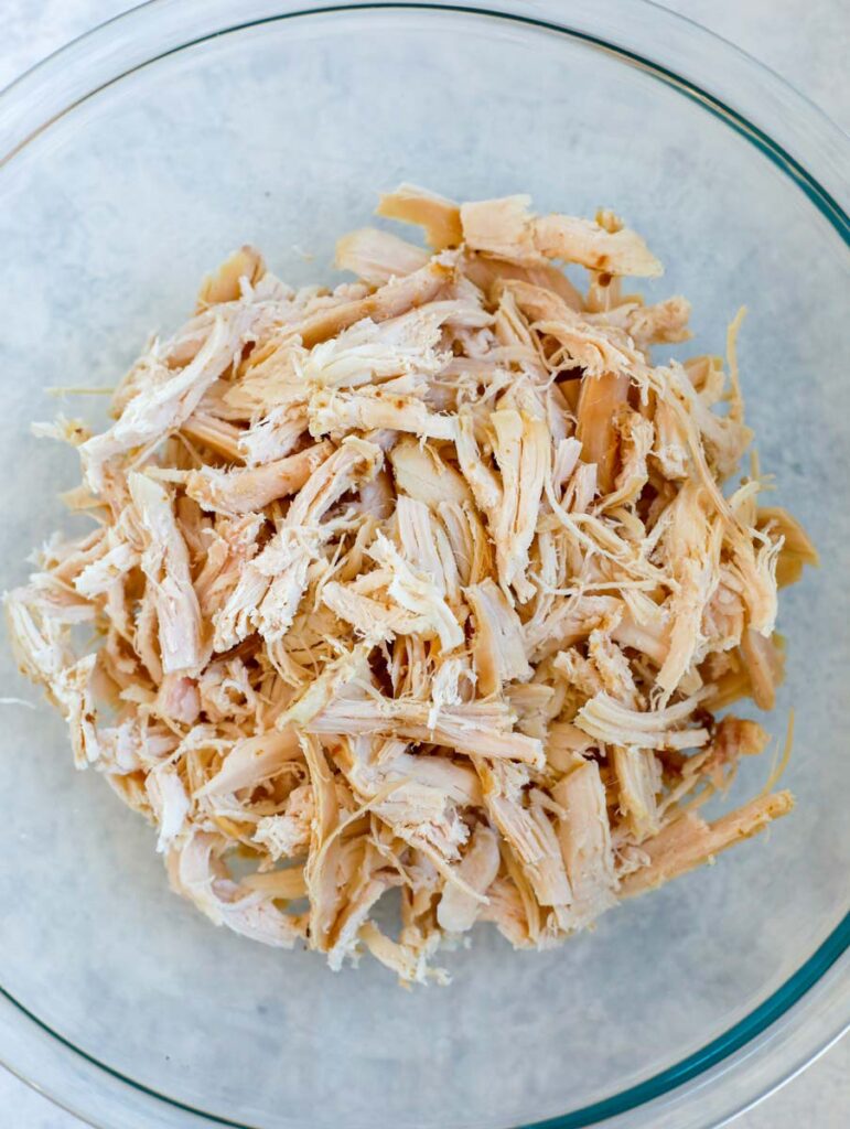 shredded chicken in a glass bowl.