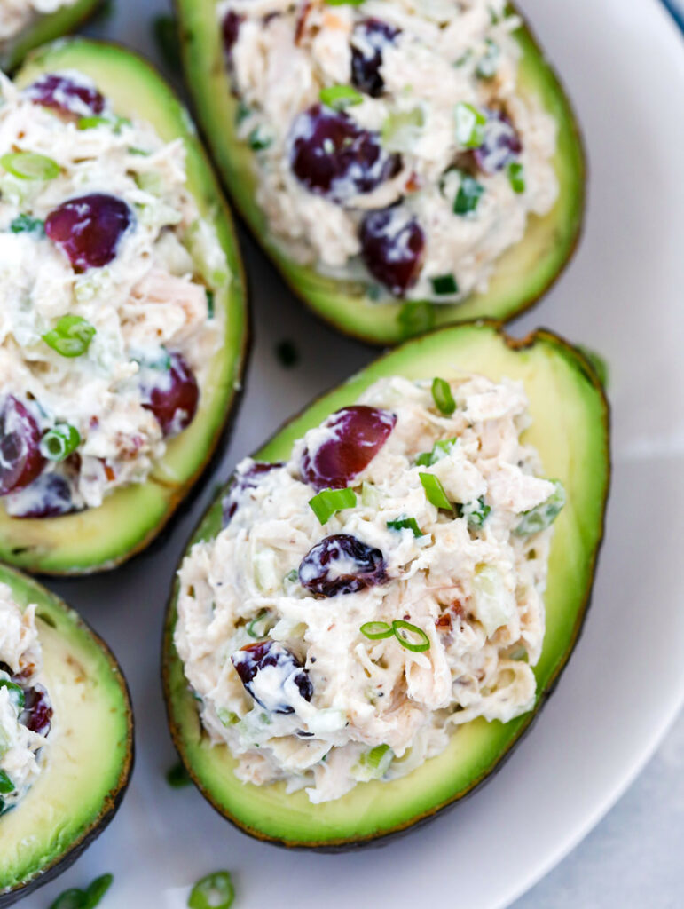 overhead shot of Stuffed Avocado on a white plate.