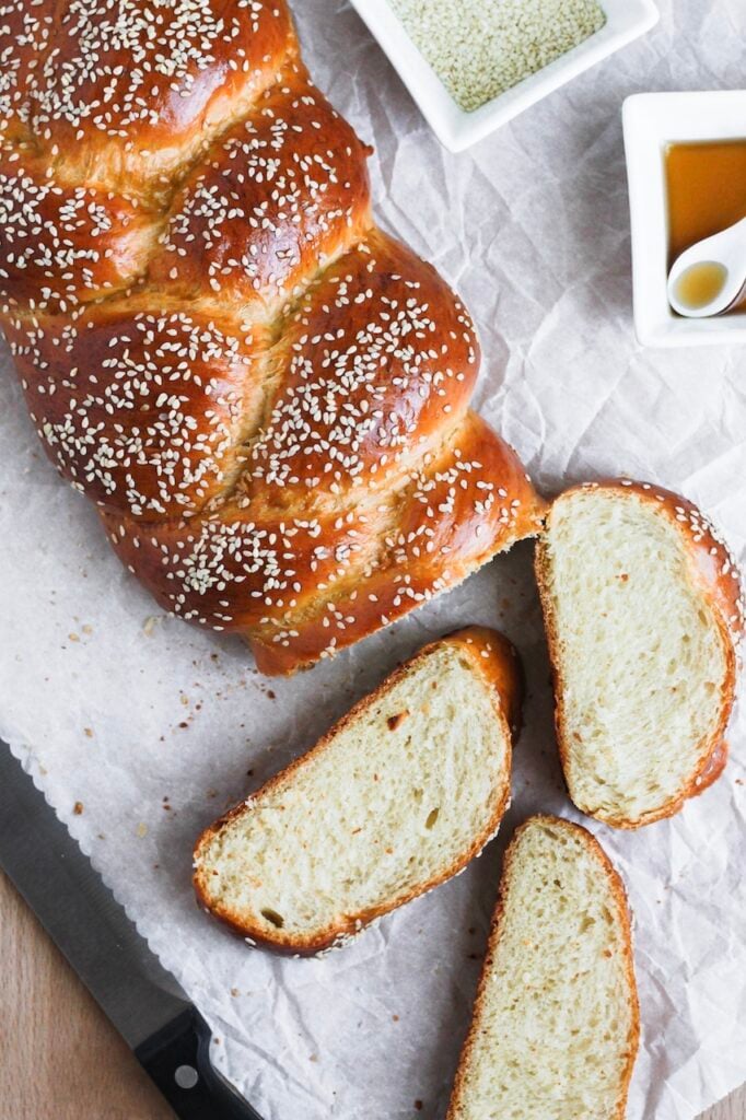 Overhead image of challah loaf sliced with three slices.