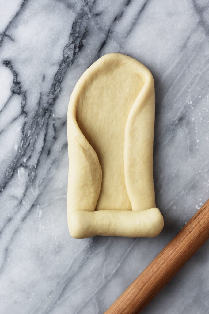 Process image of rolling the divided dough before placing it into a loaf pan.