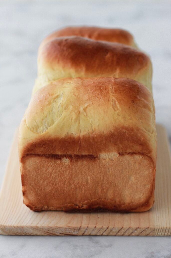 Image of an uncut loaf of freshly baked homemade sandwich bread.