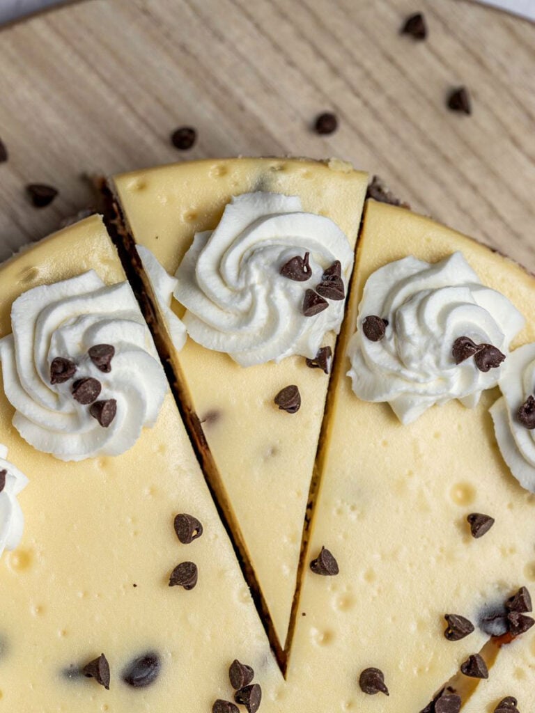 top down view of chocolate chip cheesecake with a slice cut out