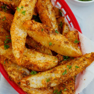 Golden baked potato wedges seasoned with Parmesan, herbs, and spices.