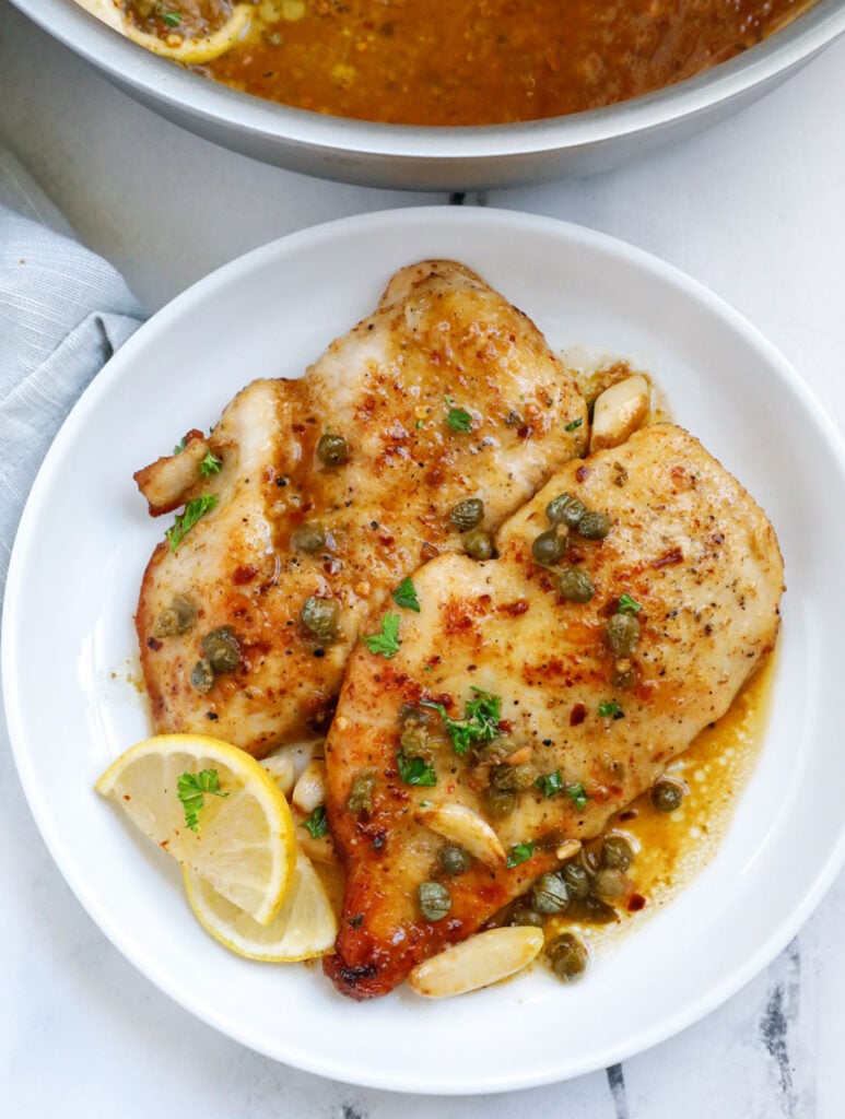 chicken piccata pieces on a white plate