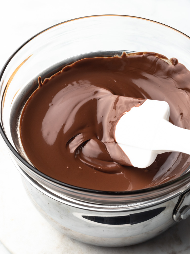 melted chocolate in a double boiler with a spatula in it.