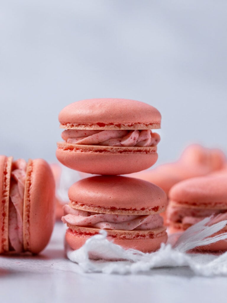 A stack of three strawberry macarons.
