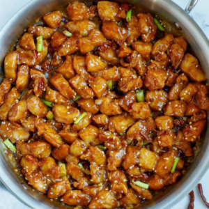Sticky glazed chicken with dried chilies, green onions, and sesame seeds.