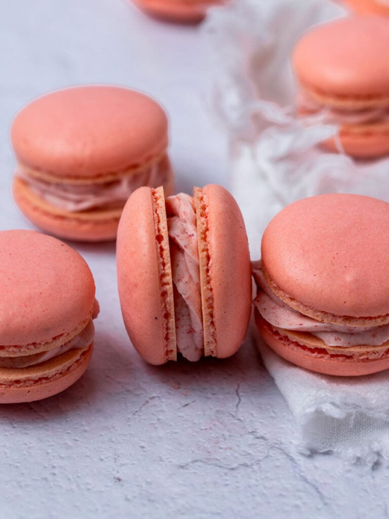 A group of pink French macarons.