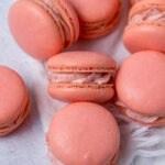 Close up of French macarons with strawberry cream filling.