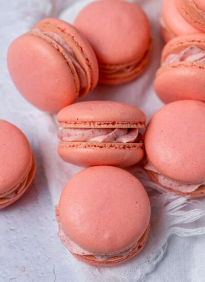 Close up of French macarons with strawberry cream filling.