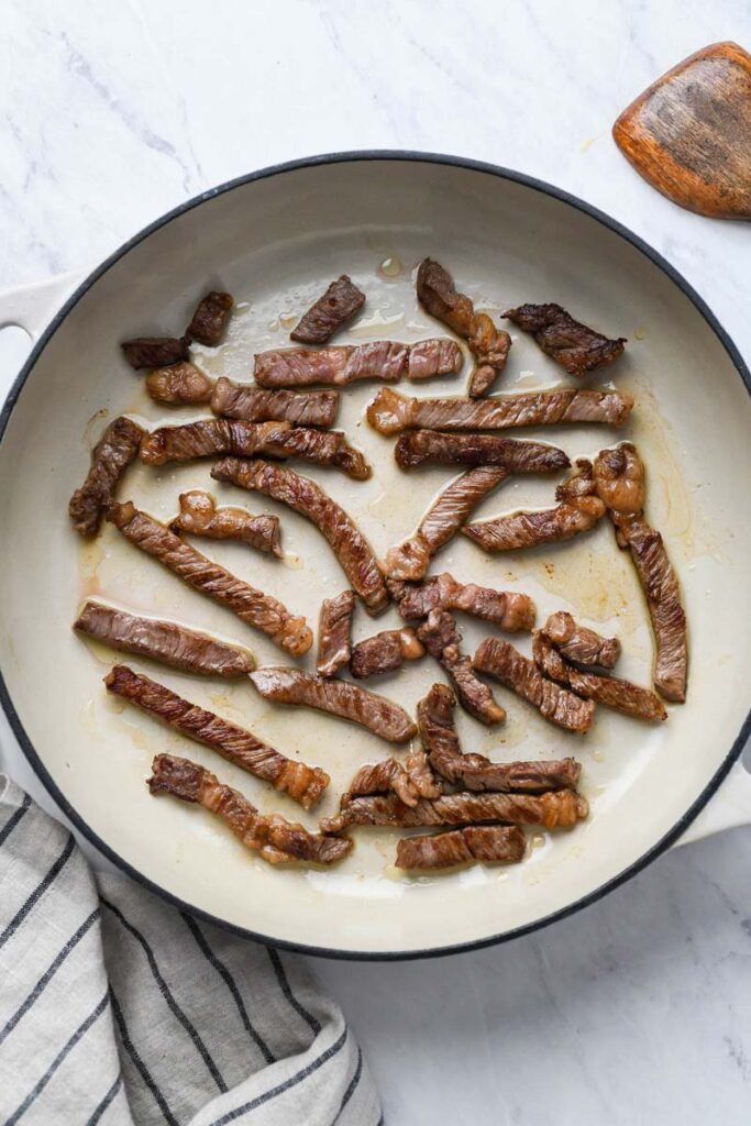 cooked beef strips in a skillet