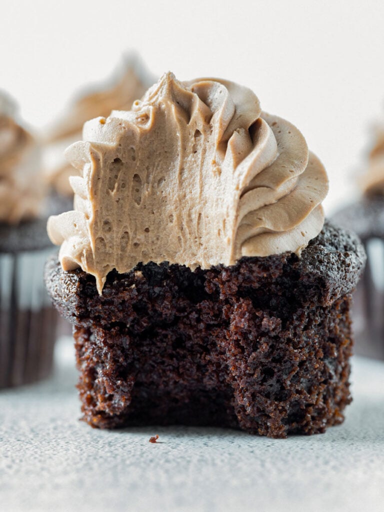 close up shot of chocolate cupcake with a bite taken out of it