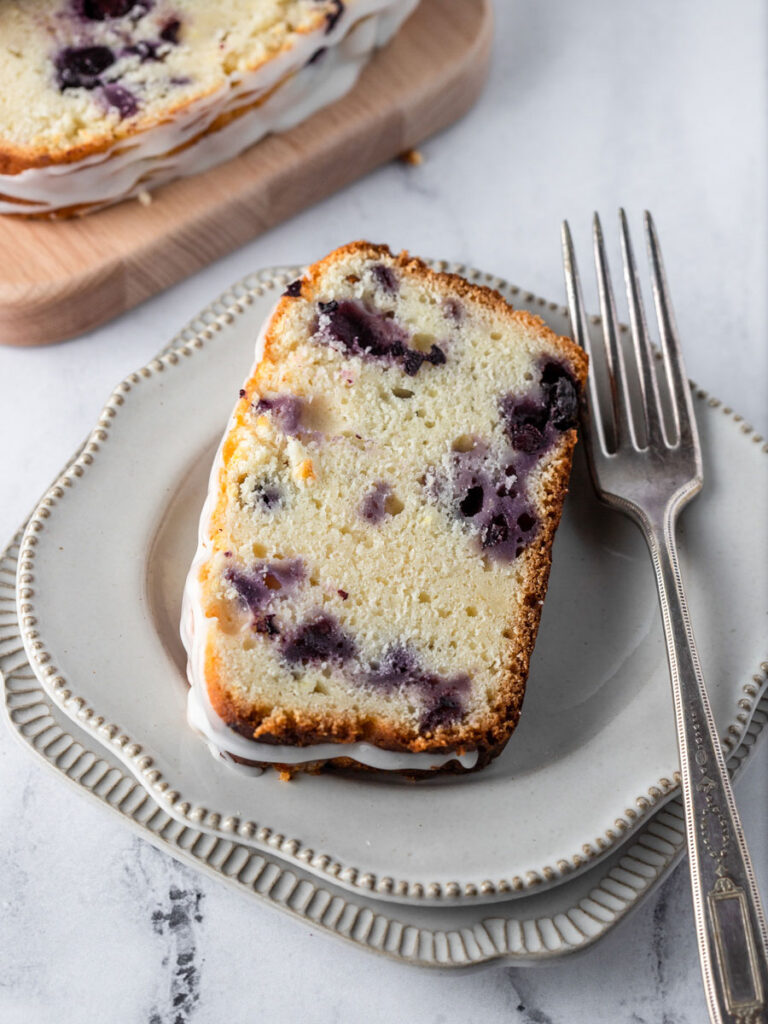 a slice of blueberry lemon bread on a plate