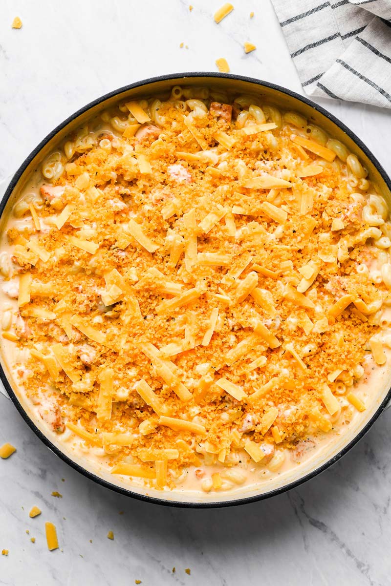 man n cheese topped with cheese and bread crumbs in a skillet