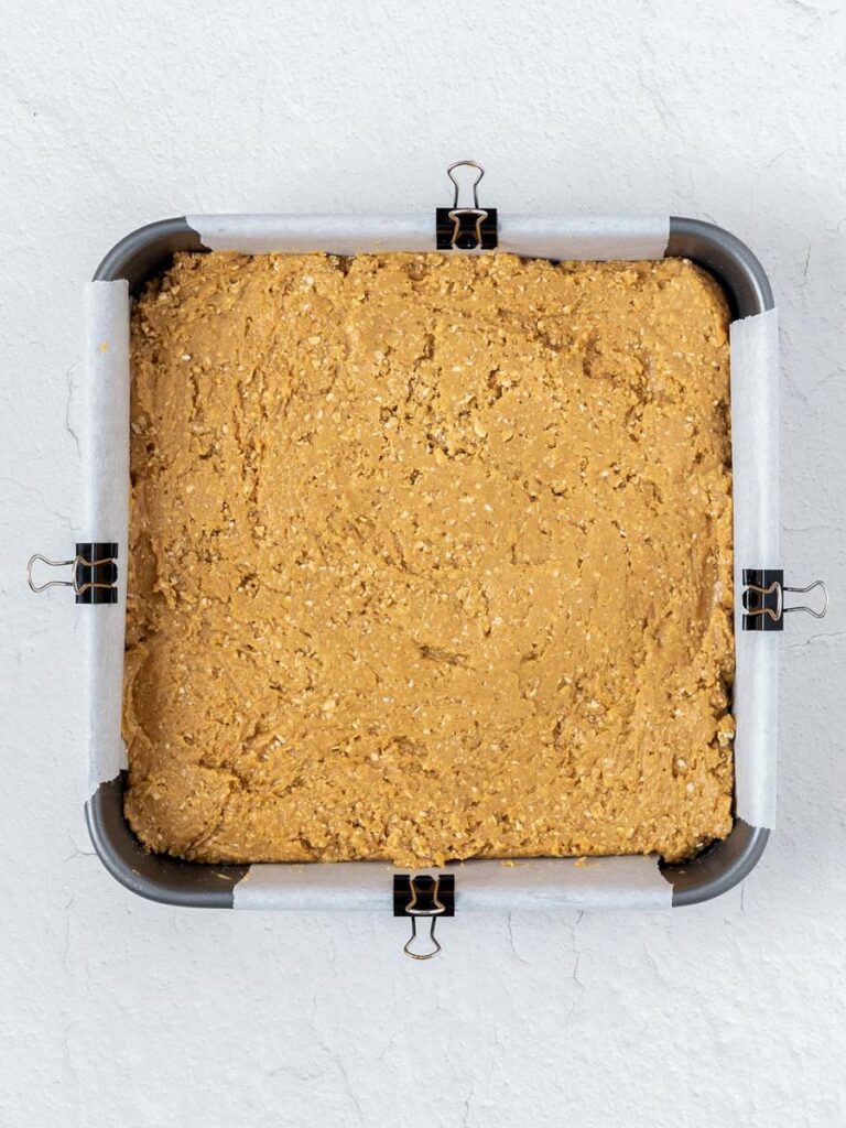 top down shot of the peanut butter mixture in a square pan