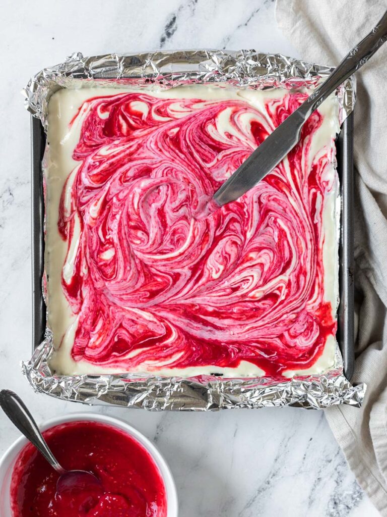 top down shot of the cheesecake filling in a square pan