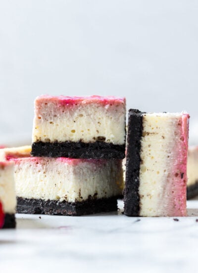 two cheesecake bars stacked up with one on the side