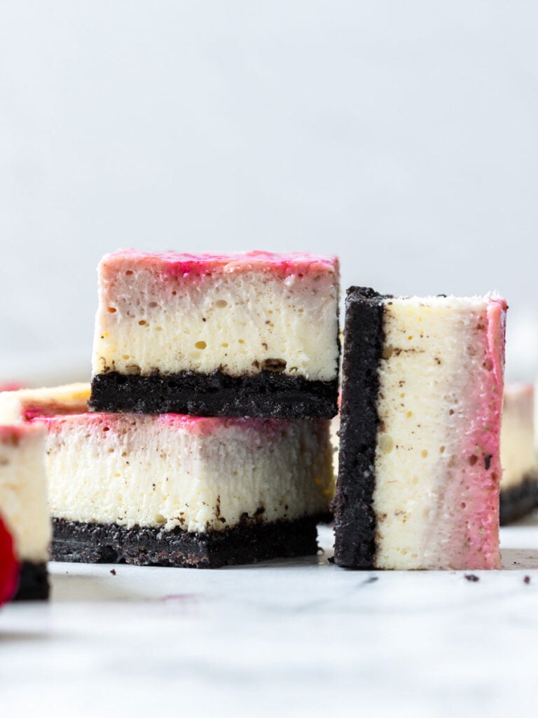 two cheesecake bars stacked up with one on the side