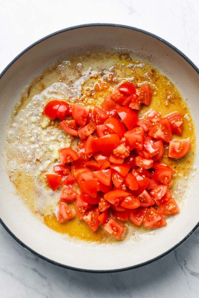top down view of tomatoes in a skillet