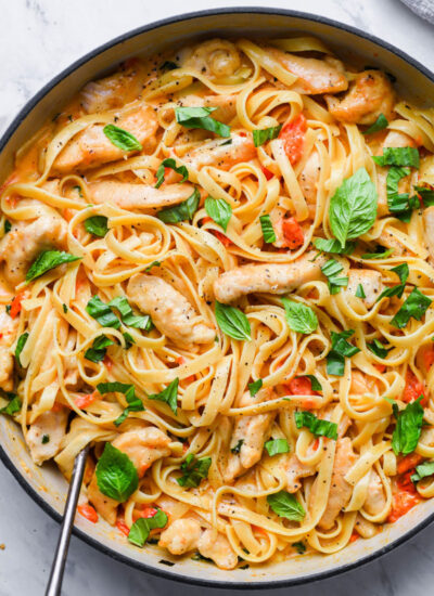 top down view of creamy tomato basil pasta in a skillet