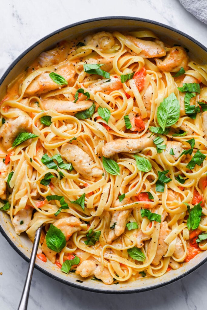 top down view of creamy tomato basil pasta in a skillet