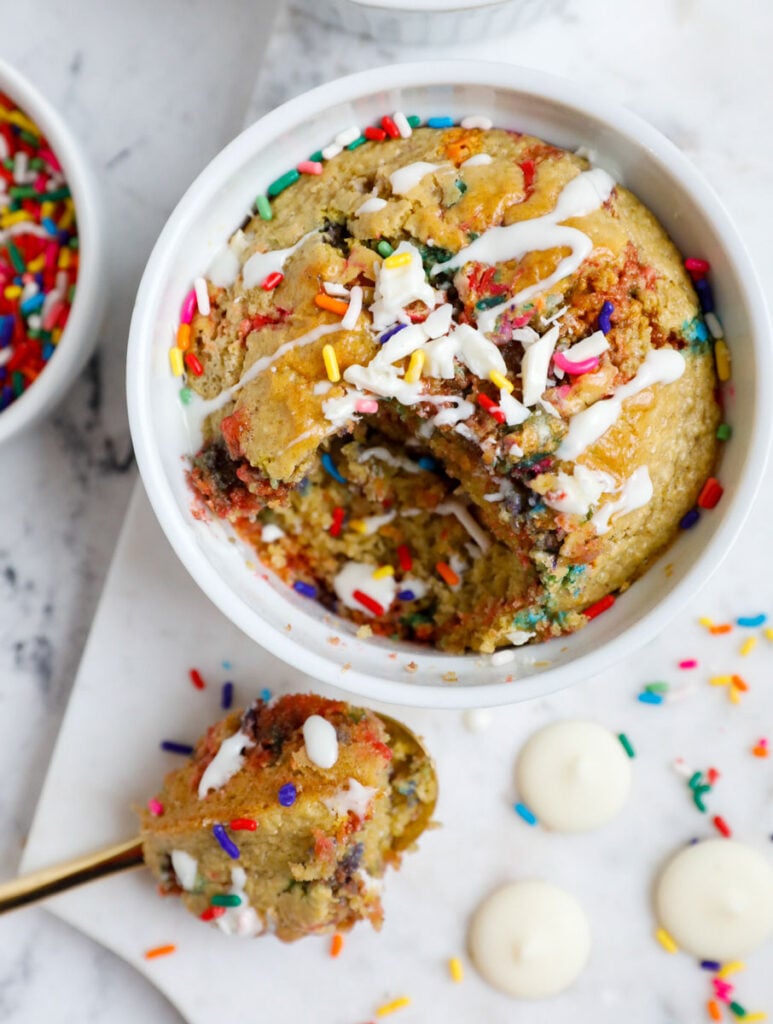 Baked funfetti oat cake with a spoonful scooped out.