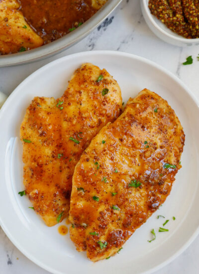 A plate of chicken with honey mustard sauce.