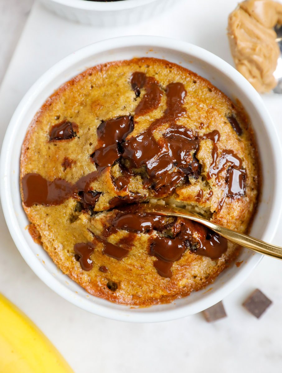 Spoon going into a ramekin of banana chocolate baked oats.