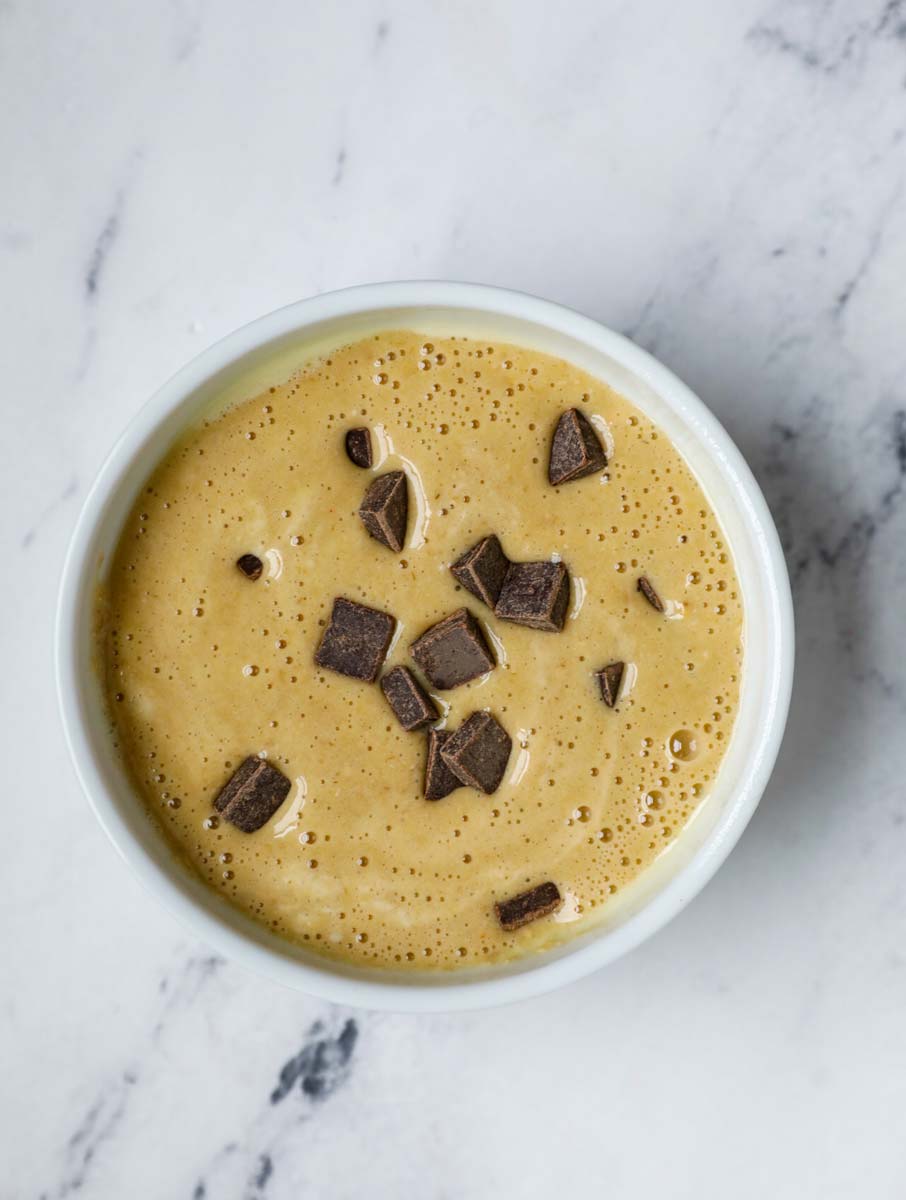 Chocolate chip banana baked oats batter in a ramekin.