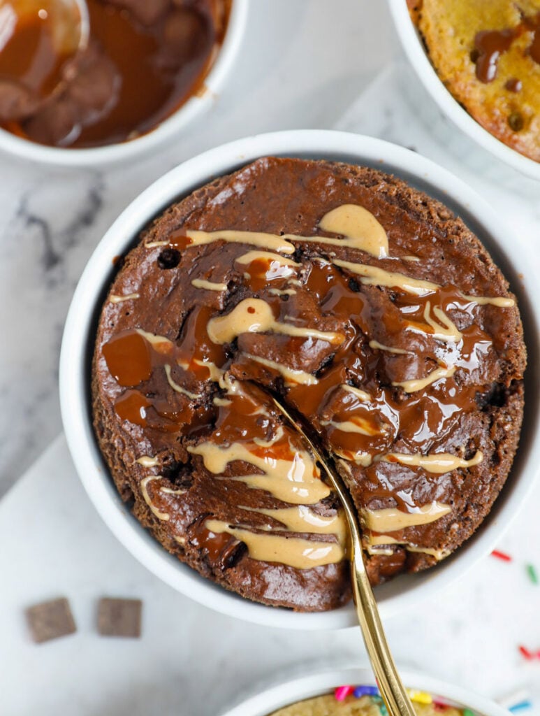 A spoon inserted into a ramekin of baked oats.