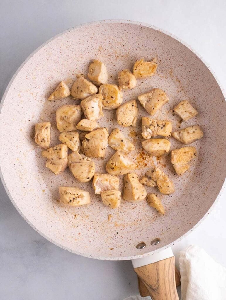 cooked chicken cubes in a skillet