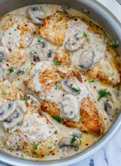 Overhead view of creamy mushroom chicken in a pot.