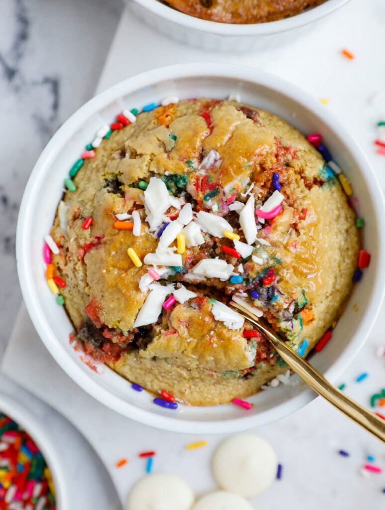 Photo of funfetti baked oats with a spoon scooping in.