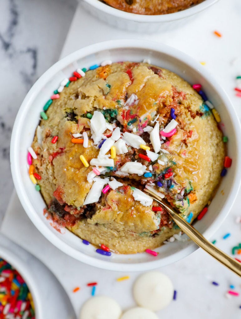 Photo of funfetti baked oats with a spoon scooping in.