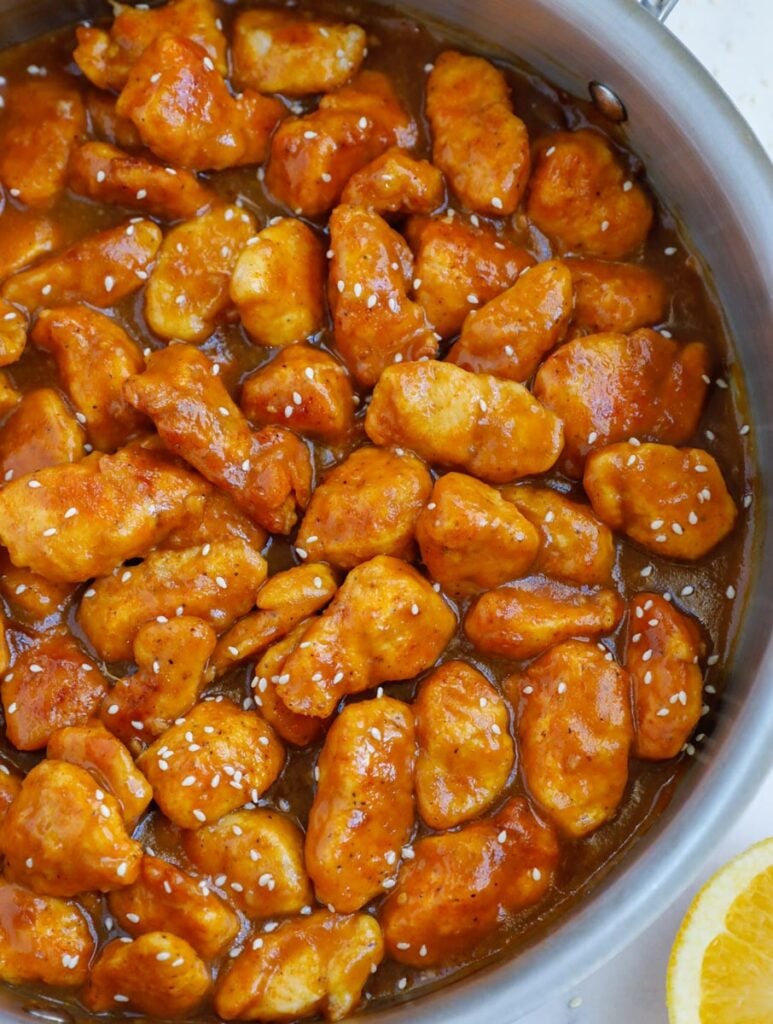 Close up of orange chicken in a pan.