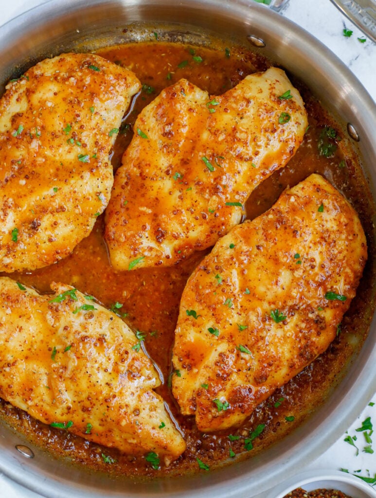 Honey mustard chicken in a pan.