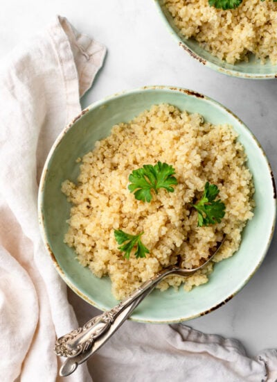 cooked quinoa in a plate garnished with fresh parsley