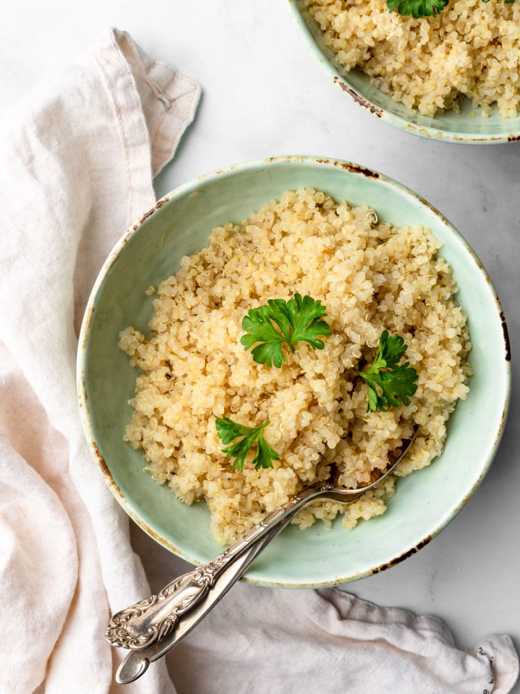 cooked quinoa in a plate garnished with fresh parsley