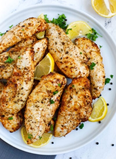 Top down view of lemon pepper chicken on a plate.