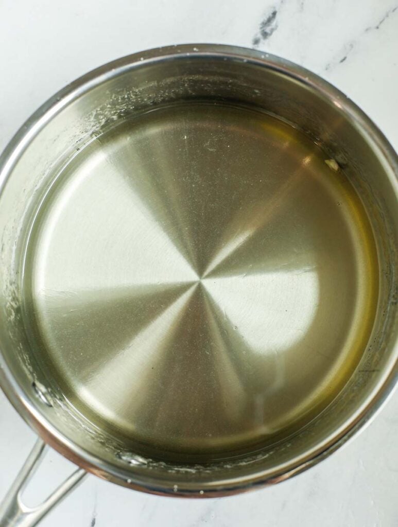 Sugar syrup inside a saucepan.
